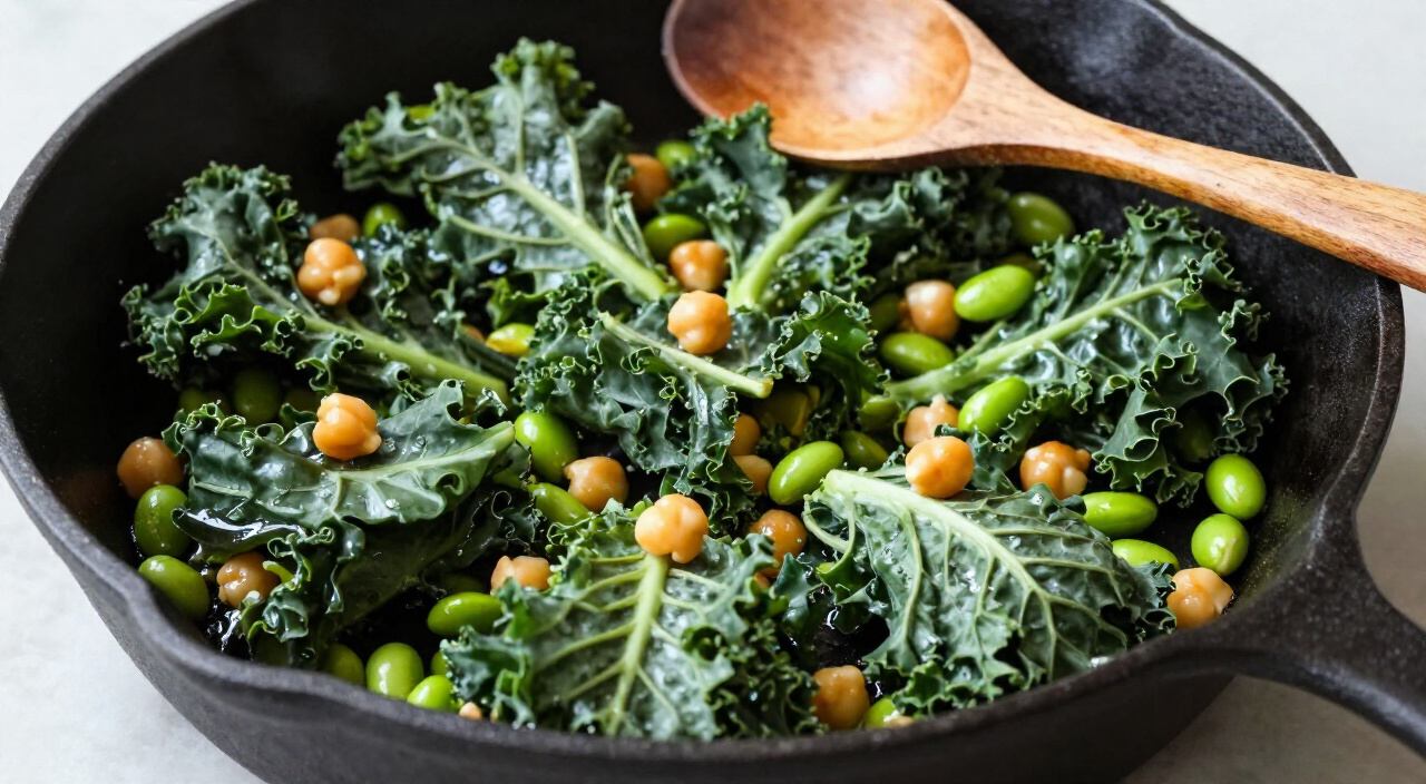 Wilted lacinato kale tossed with chickpeas and edamame in a cast iron skillet